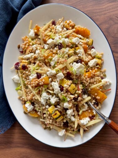 Overhead shot of fall couscous salad on a platter.